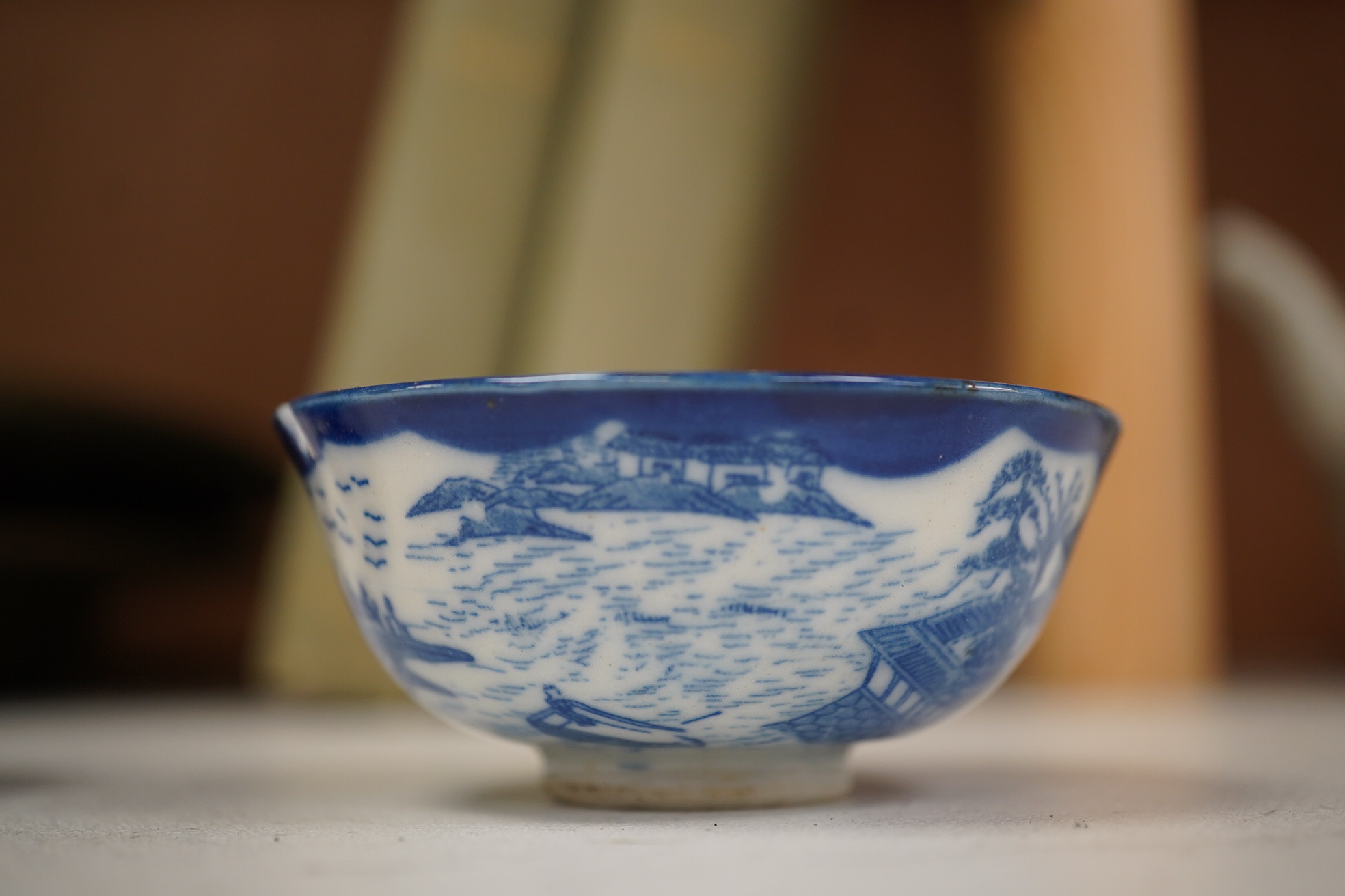 A group of Chinese blue and white porcelain, including a mid 19th century Canton enamel teabowl and a Japanese small dish, tallest 22cm. Condition - fair